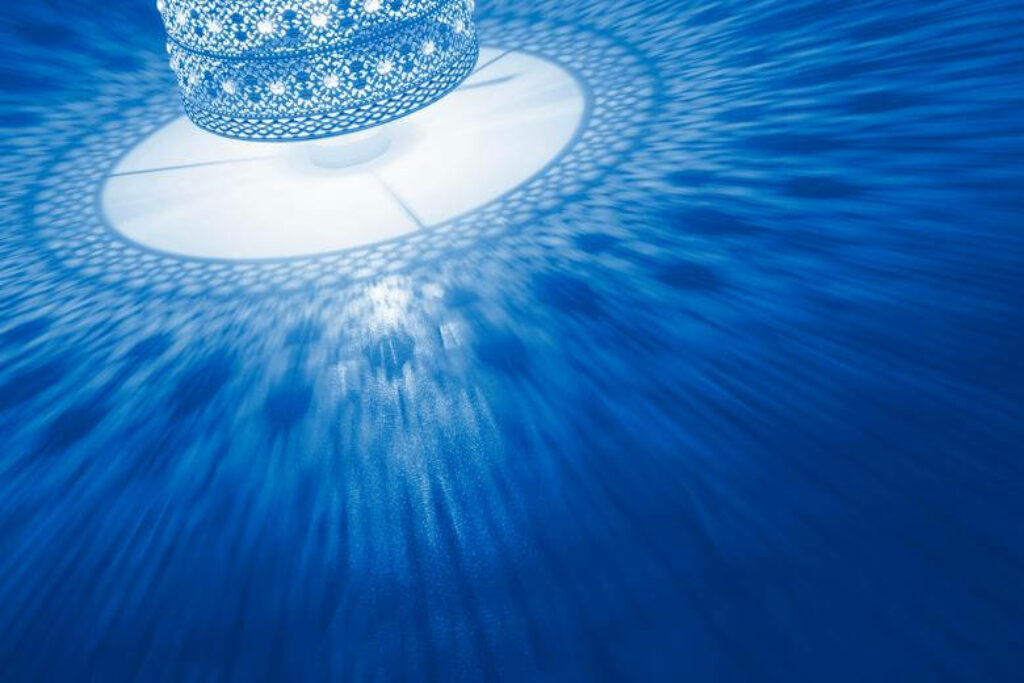 Magnificent Glow: Revealing the Ornate Patterns on a Brilliant Blue Lamp Shade - Ideal for Cool Simple Backgrounds Wallpaper