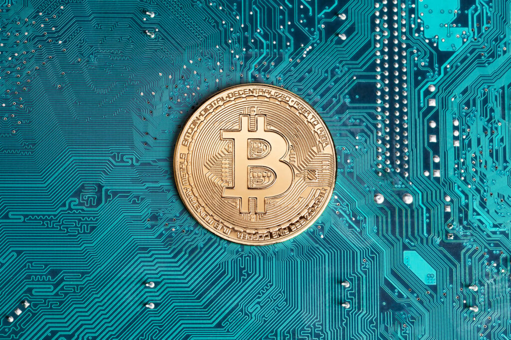 Gold Bitcoin coin on blue circuit board representing cryptocurrency integration digital technology Wallpaper