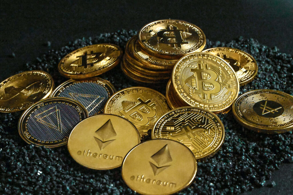Gold-plated Bitcoin Ethereum and digital cryptocurrency coins on dark textured finance background Wallpaper