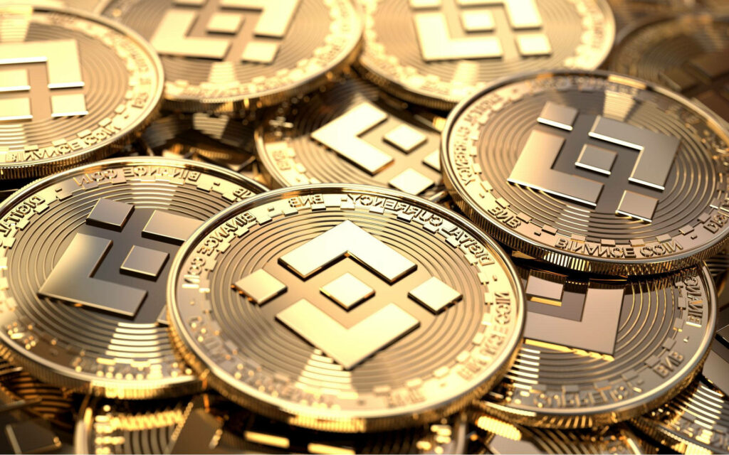 Shiny golden Binance coins with logo representing cryptocurrency wealth and digital success wallpaper
