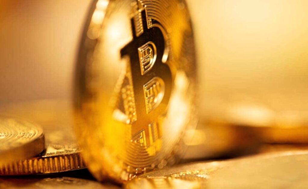Gold Bitcoin coin with iconic cryptocurrency symbol digital wealth crypto investment wallpaper