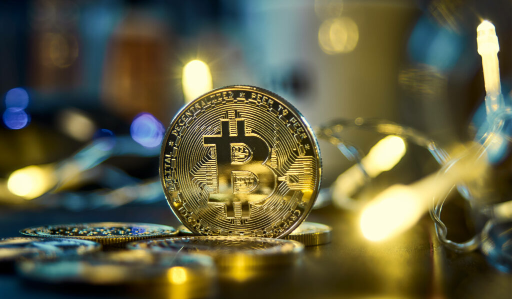 Golden Bitcoin standing upright with glowing lights digital currency innovation wallpaper background