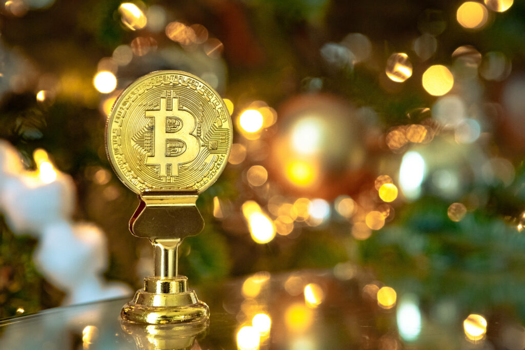 Golden Bitcoin trophy shines brightly with festive lights symbolizing crypto investment success Wallpaper