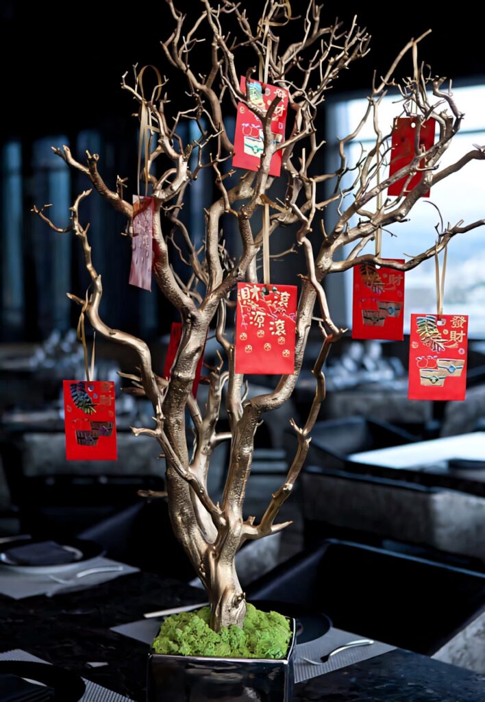 Golden tree with red Chinese New Year envelopes symbolizing prosperity festive wallpaper background