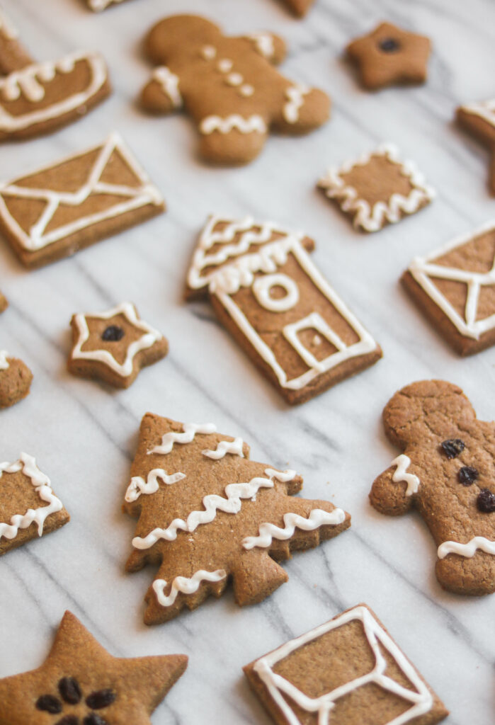 Gorgeous Gingerbread Delights: A Festive Array of Handcrafted Cookies Set on Elegant Marble Background Wallpaper