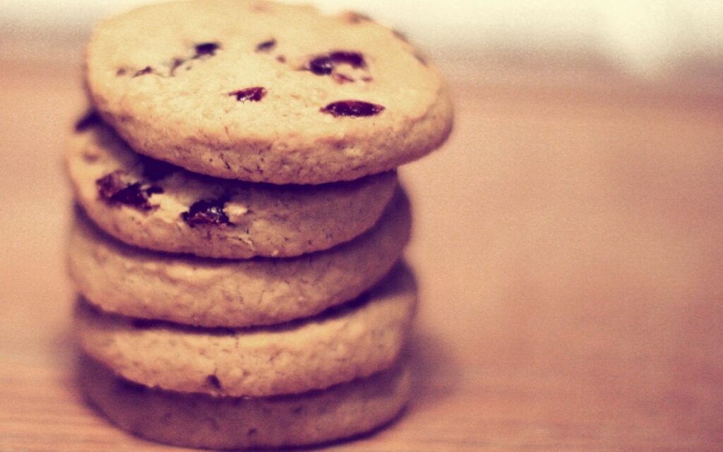 Golden-Brown Raisin Cookies on Wood - Tasty Wallpaper Background