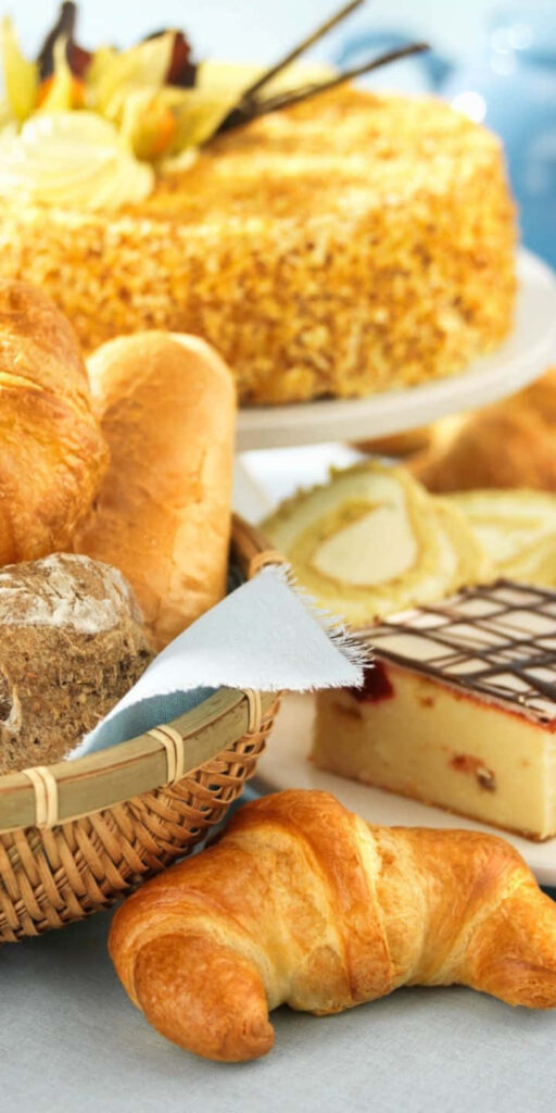 Golden croissants rustic breads and decadent cake pastry wallpaper with soft natural lighting