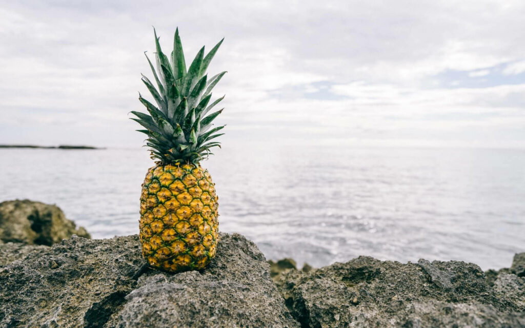 Golden Bliss: A Tropical Paradise with the Scent of Ripe Pineapple and the Soothing Sound of Crashing Waves Wallpaper