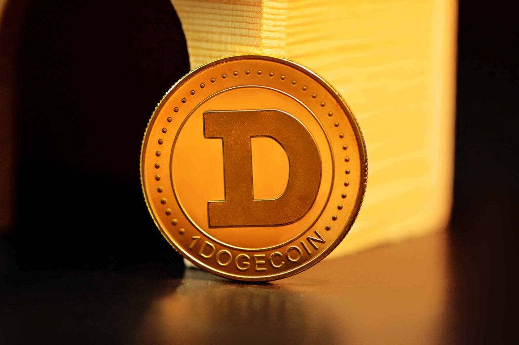 Close-up of shiny golden Dogecoin with D emblem on warm background symbolizing crypto value Wallpaper