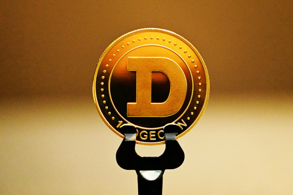 Golden Dogecoin symbol on warm gradient background digital currency wallpaper design