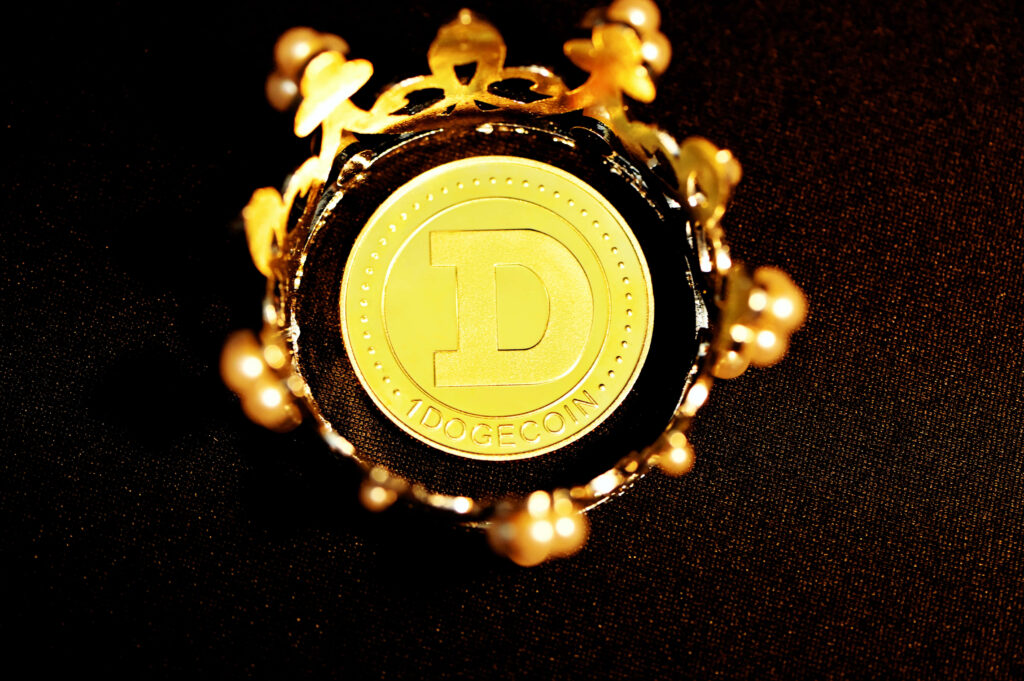 Golden Dogecoin inside ornate crown on dark textured background symbolizing crypto wealth Wallpaper