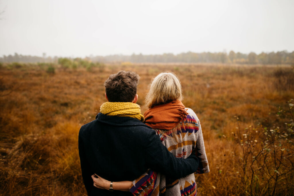 Embracing Love amidst a Golden Natural Setting: The Perfect Background Photo for In Love Couples Wallpaper