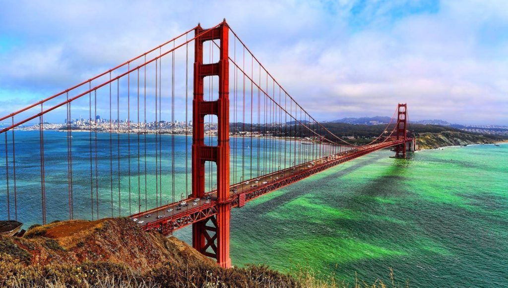 Golden Gate Bridge in San Francisco over turquoise Pacific with coastal hills and clear sky wallpaper