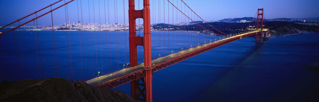 Golden Gate Bridge at twilight with San Francisco skyline and deep blue bay panoramic wallpaper