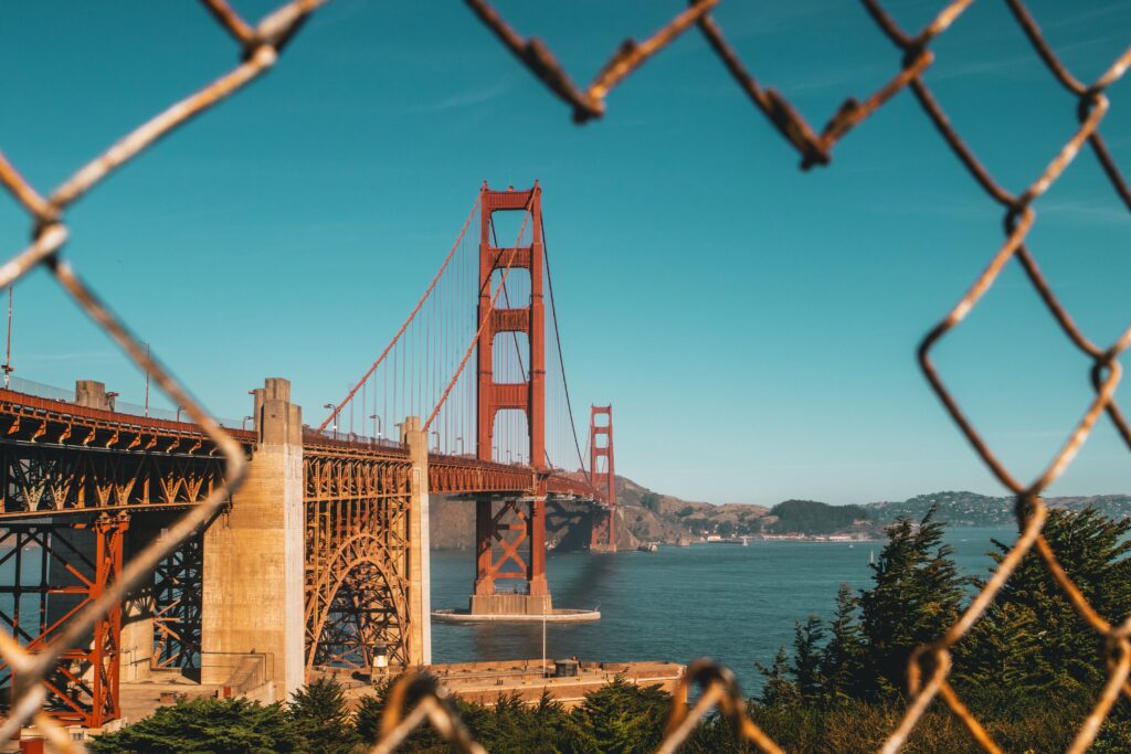 Golden Gate Bridge Wallpaper: Scenic View Through Chain-Link Fence