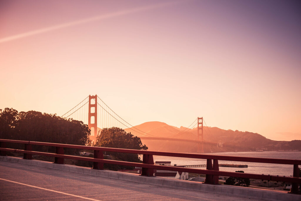 Serenity Reflected: Golden Gate Bridge Sunset Graces Laptop Aesthetic Wallpaper