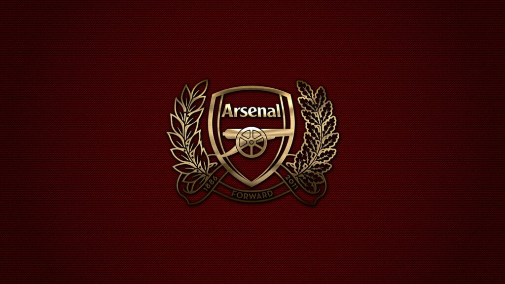 Golden Glory: Arsenal's Iconic Logo Shines on Red Wallpaper
