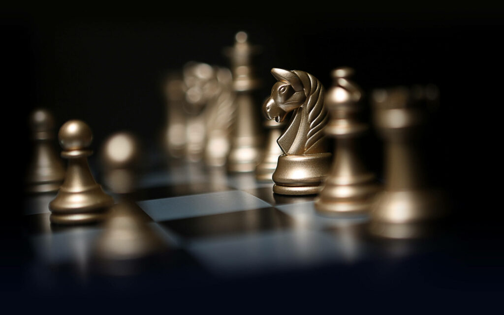 Glamour in Focus: Mesmerizing 8K Ultra HD Wallpaper of Shimmering Gold Chessboard Pieces Enhanced with Vignette Effect