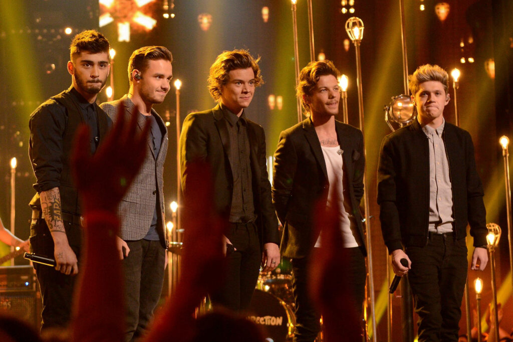 Radiant Illumination: The Captivating One Direction Boys Bathed in Majestic Golden Light Wallpaper