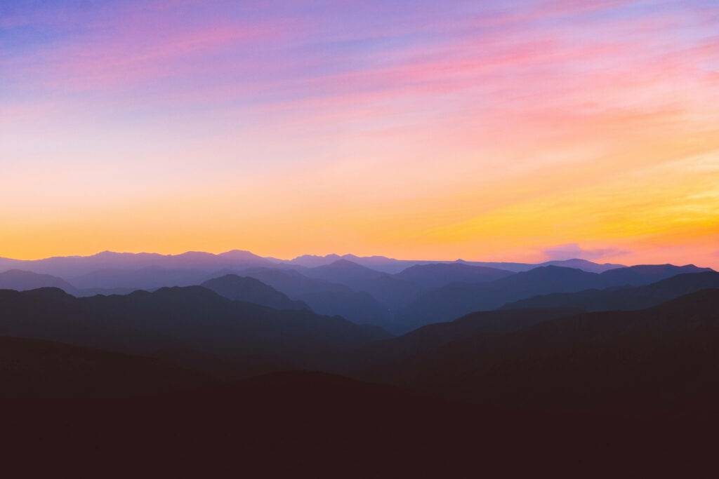 Golden Skies: Capturing the Majestic Silhouette of a Mountain Ridge in Nature's Scenic Backdrop Wallpaper