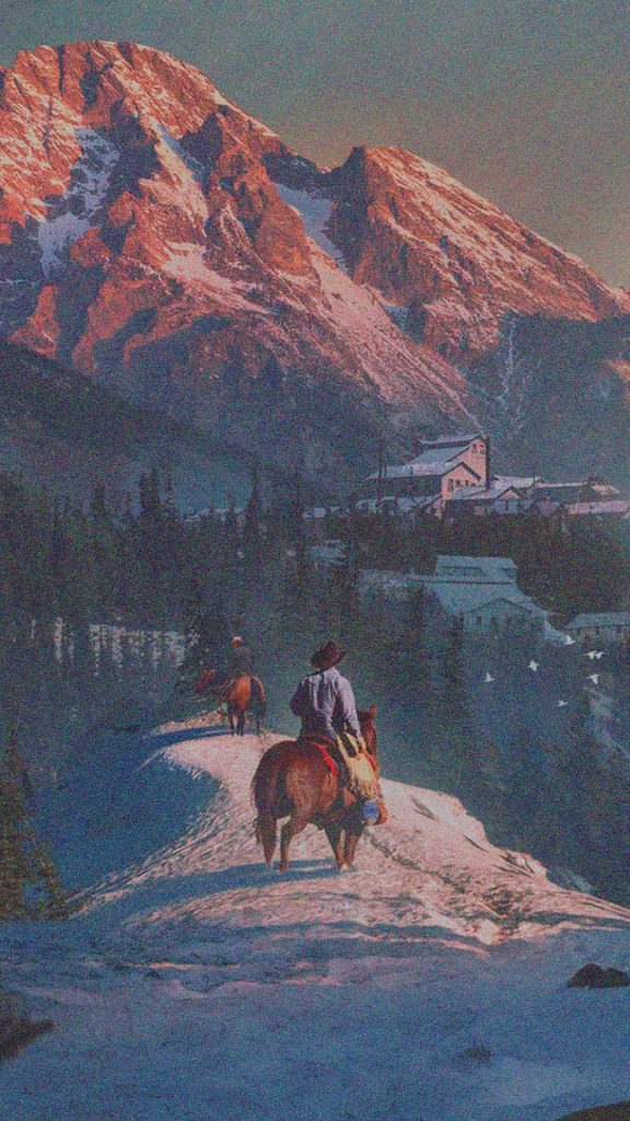 Two cowboys on horseback riding a snowy mountain ridge at golden hour with pine trees Wallpaper