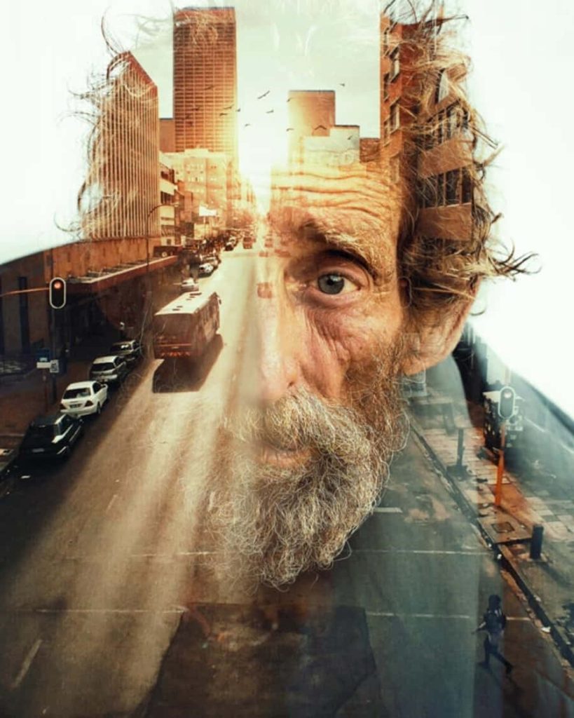 Double exposure of bearded man with blue eyes and golden city street urban architecture wallpaper