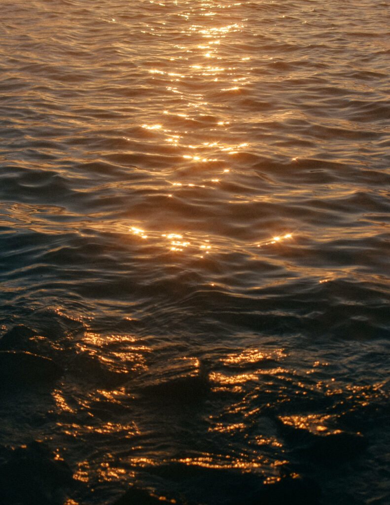 Golden Serenity: Ocean Waves and Sunlit Reflections Wallpaper