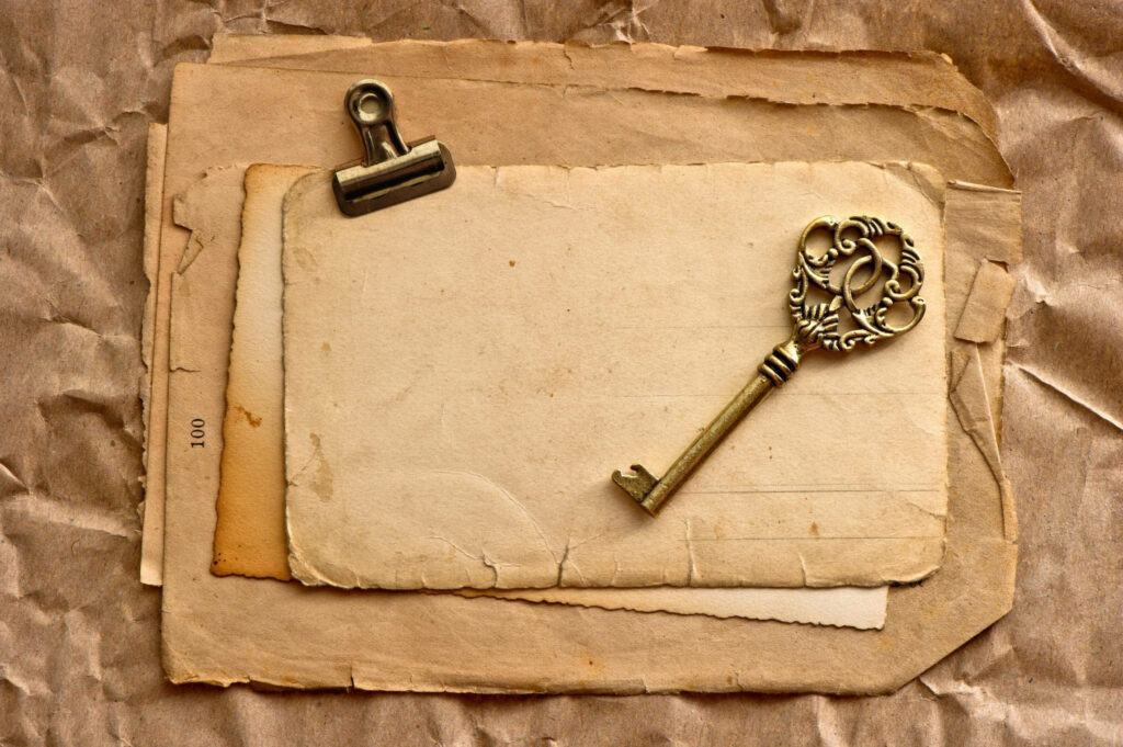 Old World Charm: Golden Key and Vintage Clip Unveiling a Parchment Tale Wallpaper