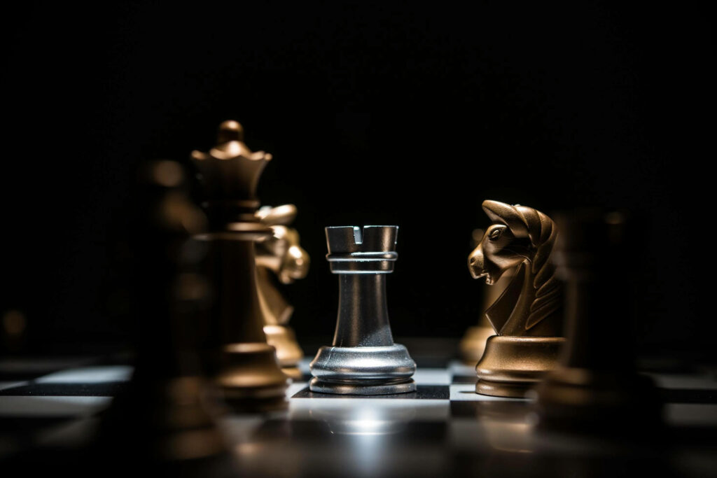 Regal Showdown: Golden Knights, Silver Rook, and the Mighty Queen Engage in an Epic Chess Battle Wallpaper
