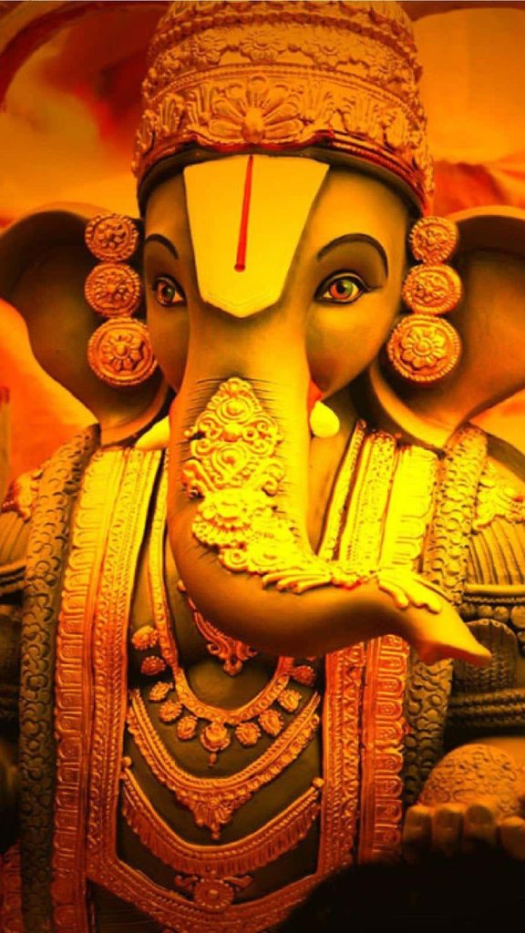 Golden Lord Ganesha portrait radiating divine energy with intricate details and warm spiritual glow Wallpaper