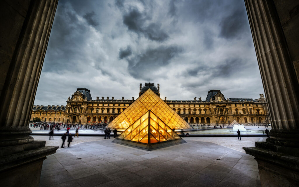 Illuminated Golden Louvre Pyramid: Stunning Wallpaper Background