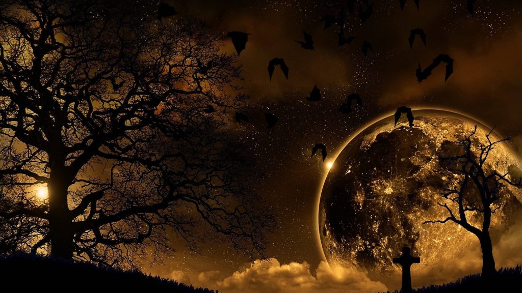 Golden moonlit graveyard with silhouetted trees bats and glowing starry amber sky digital art Wallpaper