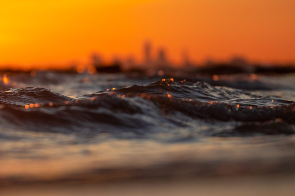 Golden Ocean Waves at Sunset: Stunning Close-Up Wallpaper Background