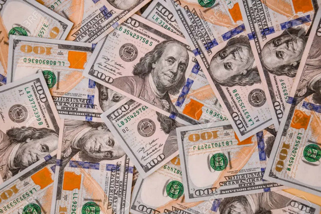 Golden Fortune: A Vibrant Stack of 100-Dollar Bills for Your Screensaver Wallpaper