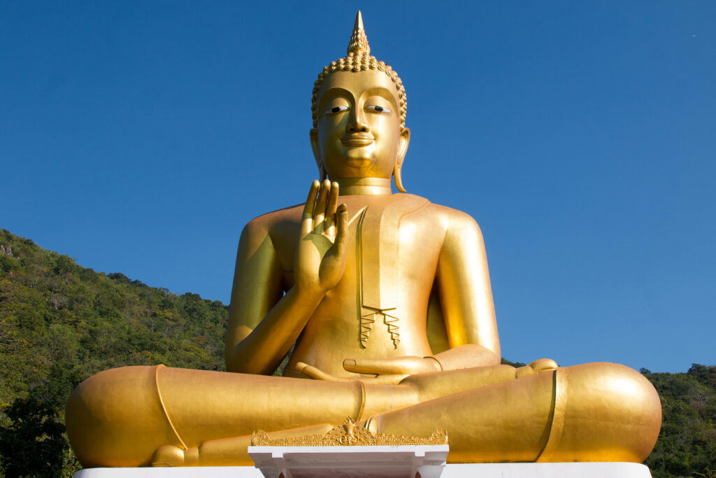 Radiant Golden Buddha Statue in Serene Forest Setting: Perfect Zen Desktop Wallpaper