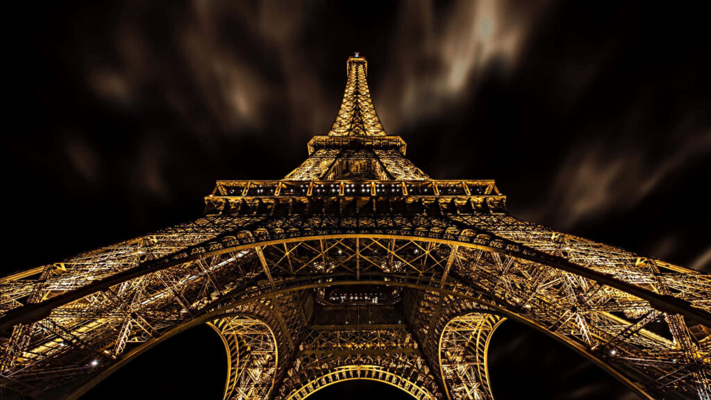 Glistening Golden Splendor: Captivating Nighttime View of the Eiffel Tower Wallpaper