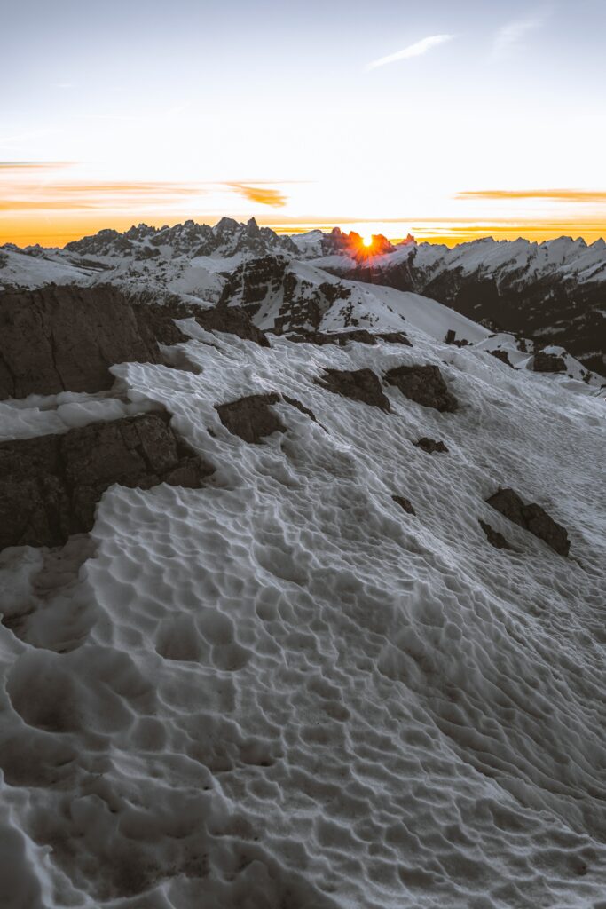 Sunset mountain landscape with snow-covered rugged slopes and dramatic distant peaks wallpaper