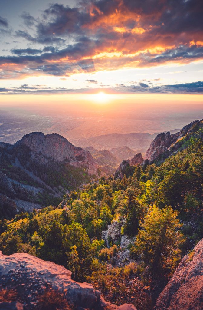 Sunset mountain iPhone wallpaper golden cliffs pine valley vibrant clouds serene view