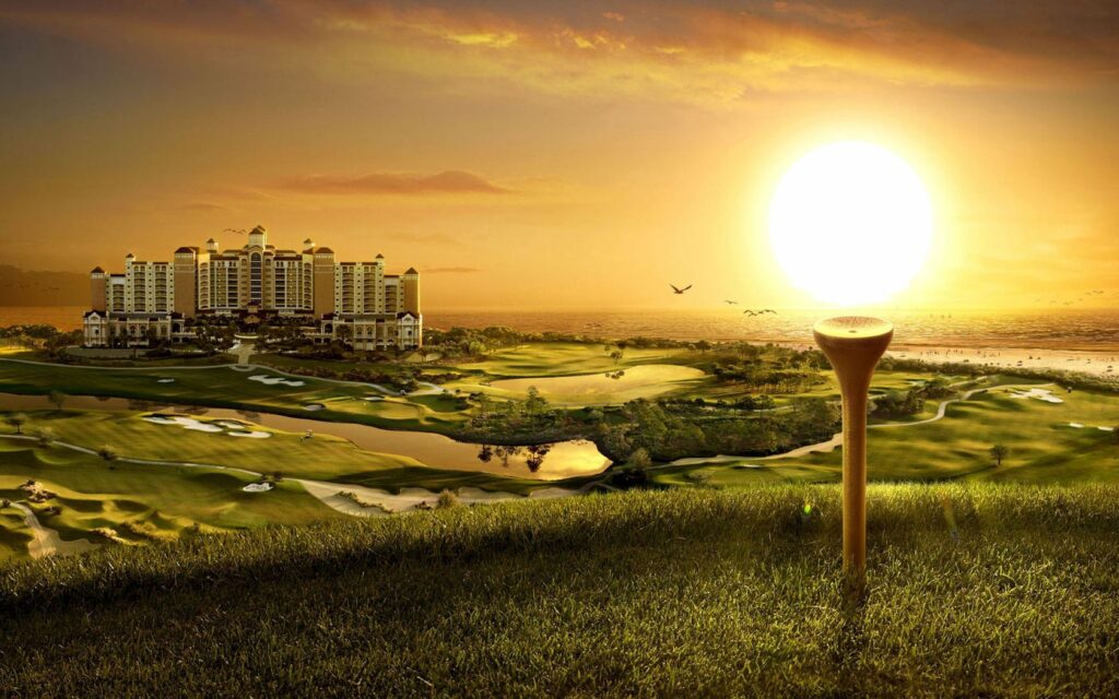 Grand building overlooking golf course at sunset with rolling greens birds and golden sky Wallpaper