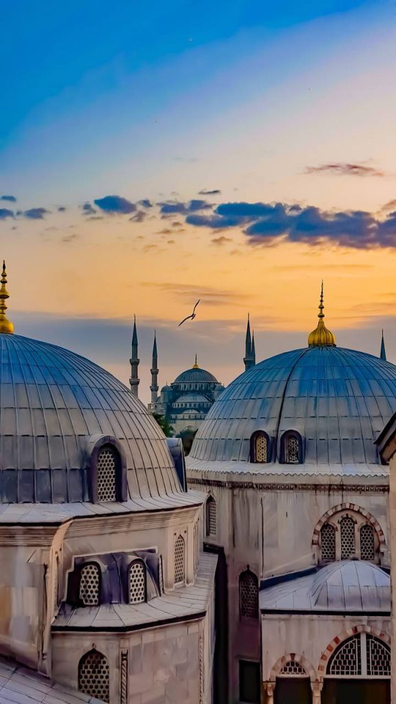 Sunset over Istanbul mosque with lead domes and lattice windows showcasing Ottoman architecture Wallpaper