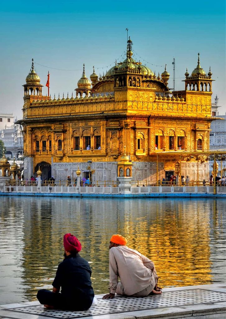 Golden Temple Amritsar sunset reflection serene Harmandir Sahib sacred pool men turbans Wallpaper
