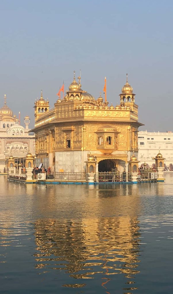 Golden Temple Amritsar gold-plated Harmandir Sahib reflected in calm Sarovar peaceful wallpaper