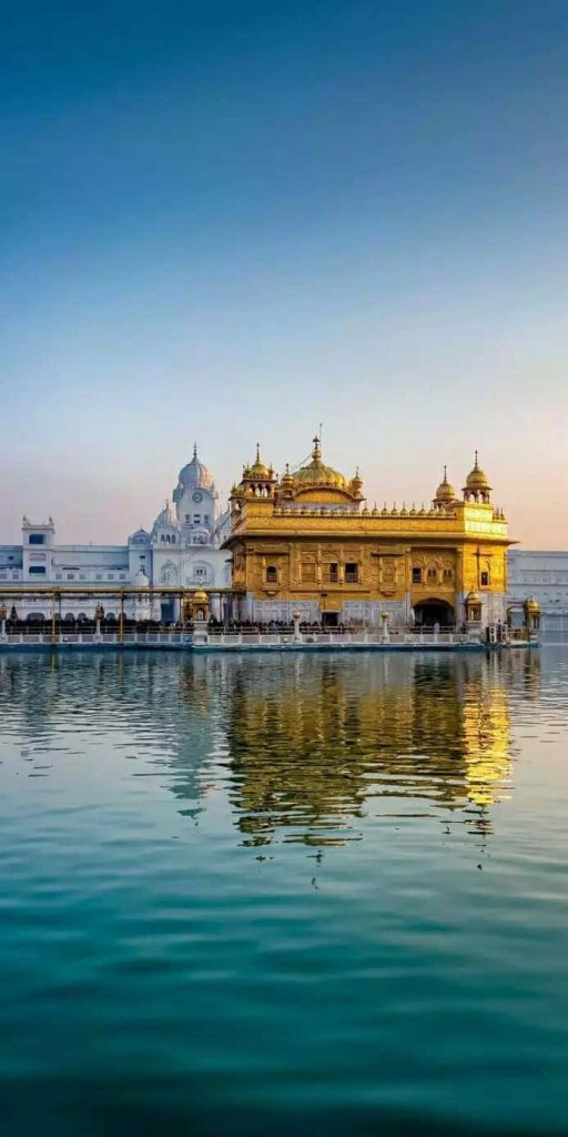 Golden Temple Harmandir Sahib reflected in calm sacred pool serene spiritual landmark wallpaper