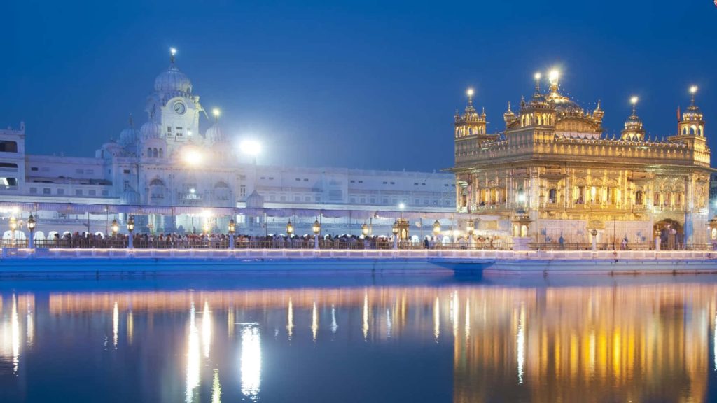 Golden Temple Amritsar night view glowing gold reflection in holy pool spiritual Sikh shrine Wallpaper
