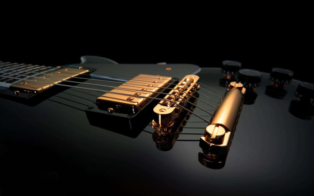 Golden Touch: Black Electric Guitar with Intricate Gold Details as Wallpaper