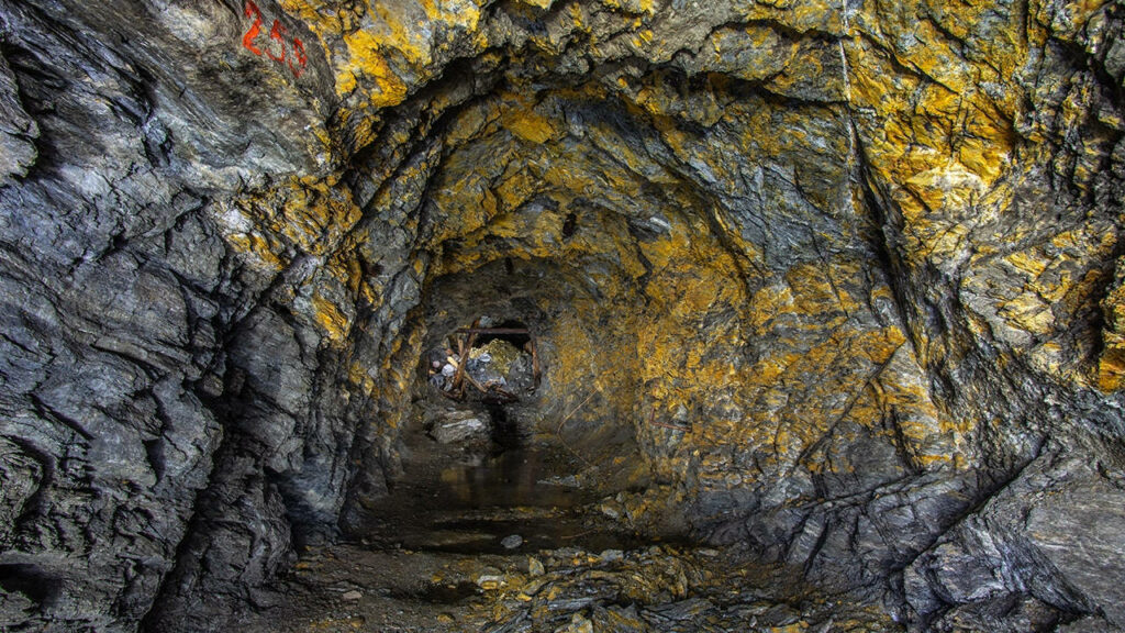 Vibrant Goldmine Adit Wallpaper: Rugged Rock & Mysterious Depths