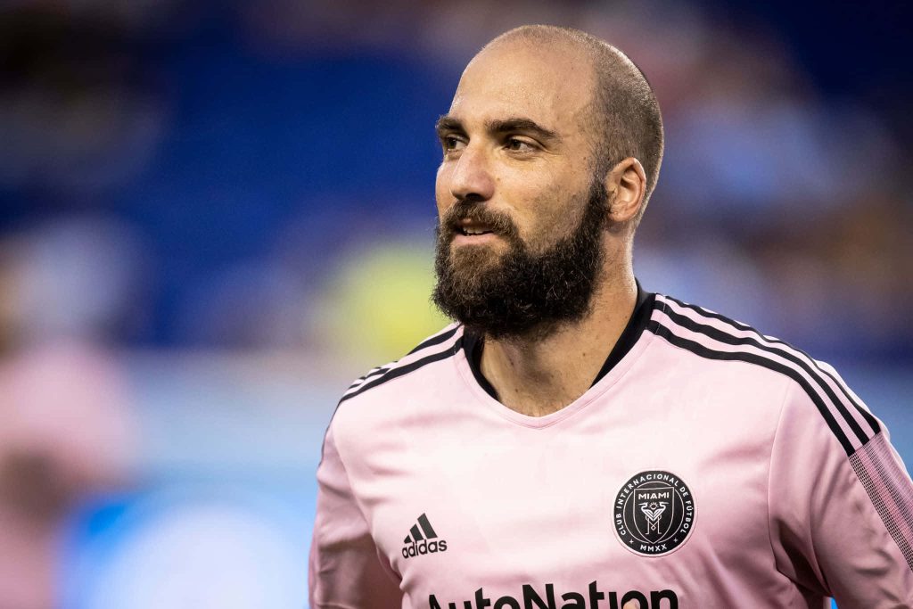 Inter Miami striker Gonzalo Higuaín in pink kit with intense gaze stadium background wallpaper