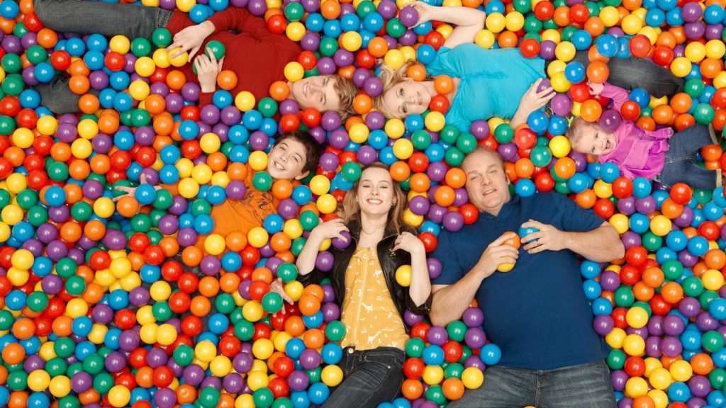 Good Luck Charlie wallpaper with Duncan family in bright colorful ball pit playful cheerful background