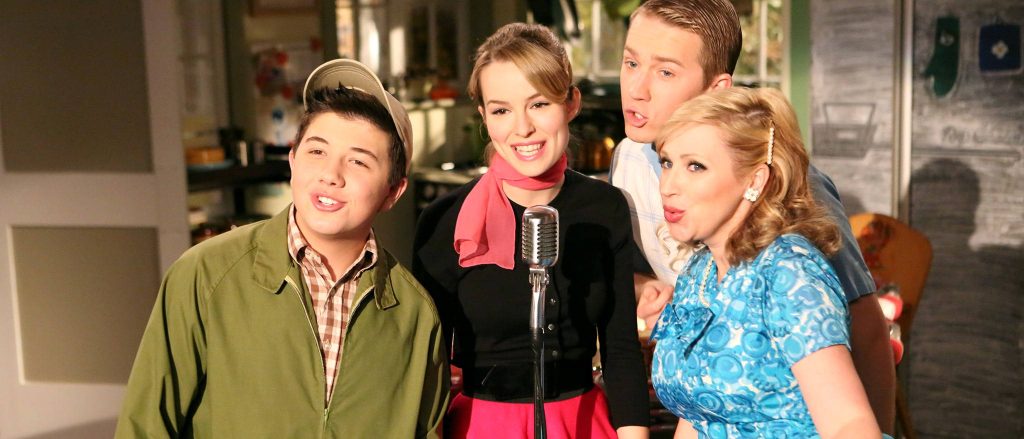 Duncan family from Disney Good Luck Charlie in 50s outfits with vintage microphone wallpaper background