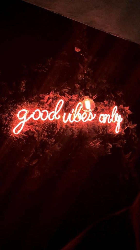 Good Vibes Only neon sign wallpaper red cursive glow dark textured background aesthetic